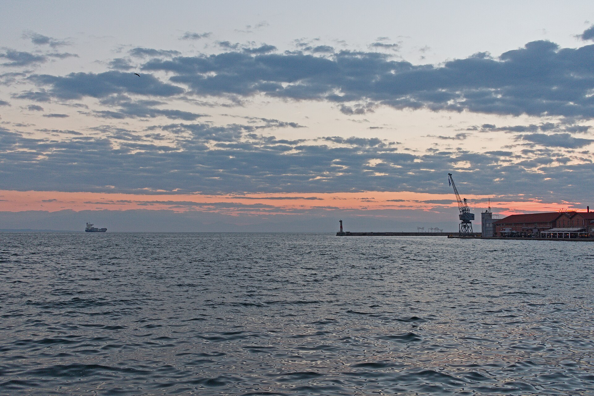 The port of Thessaloniki at dusk, cranes and the pier on a calm sea